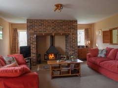 Spacious lounge with woodburner