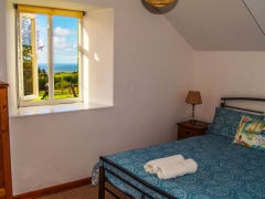 Double bedroom with countryside & sea views