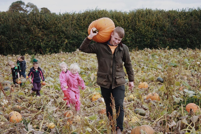 Man carrying pumpkin or a squash