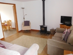 Spacious sitting room with woodburner