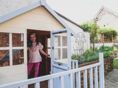 child in playhouse