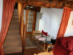 Open plan staircase and hallway to downstairs bathroom and lounge